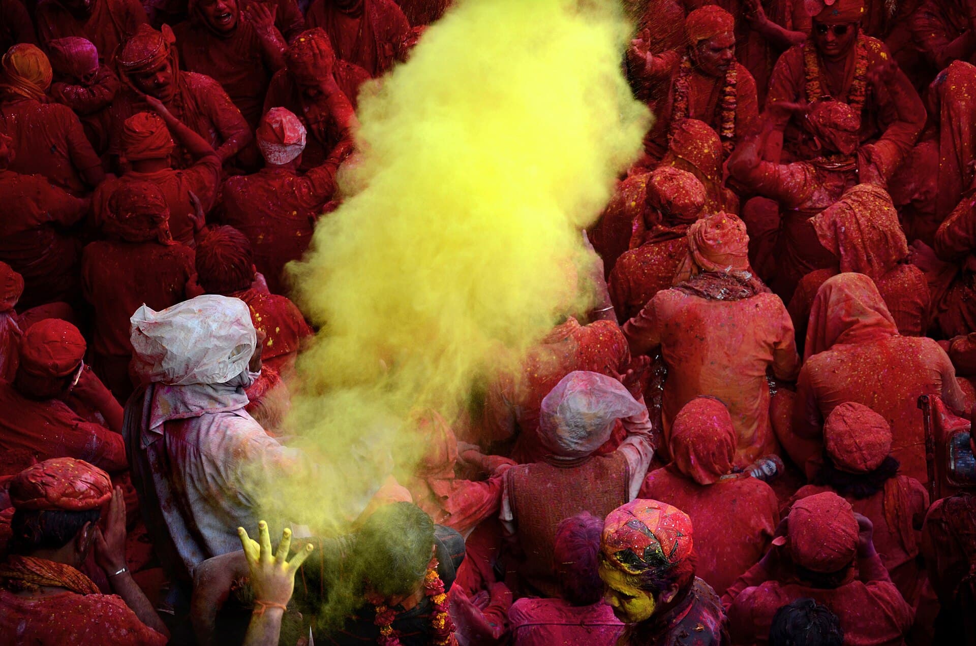 Coloured powder thrown over a crowd during Holi in India