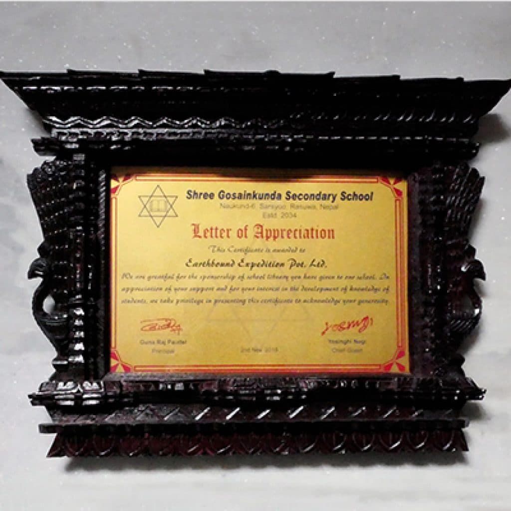Letter of appreciation from Shree Gosainkunda Secondary School in a carved wooden frame