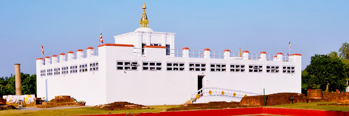 White Maya Devi Temple in Lumbini with a golden spire under a clear sky